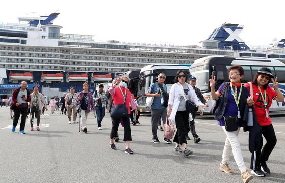 Tourists get off from the Celebrity Millenium cruise ship on May 22 in Busan. [NEWS1]