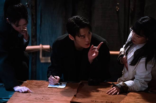 From left: Yu Ji-min, John Park and Lee Eun-ji in "Agents of Mystery" (Netflix)