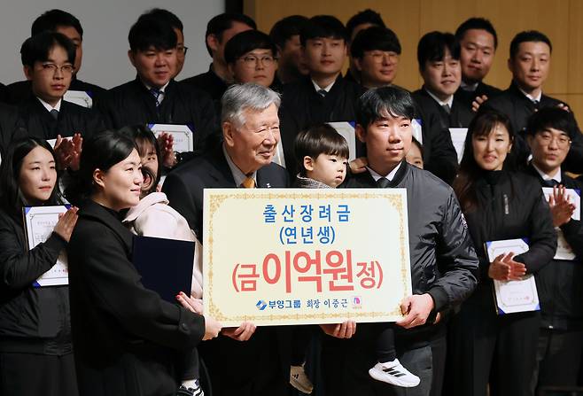 이중근 부영그룹 회장이 지난 2월 5일 서울 중구 부영빌딩에서 열린 시무식에서 다둥이 가족에게 출산장려금을 증정하고 있다. /연합뉴스