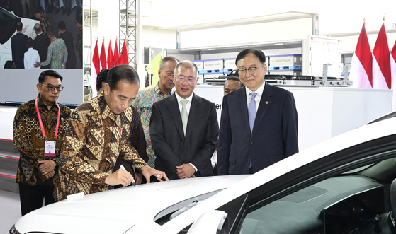 Indonesian President Joko Widodo autographs a Kona Electric at an event celebrating Hyundai Motor's completion of an EV battery plant in Karawang, Indonesia, on Wednesday. [HYUNDAI MOTOR]