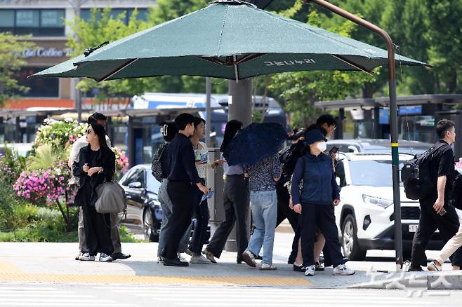 대구 등 영남 8개 지역에 올여름 첫 '폭염주의보가'가 발령되는 등 전국적으로 30도 안팎의 더위가 나타난 10일 서울 광화문사거리에서 시민들이 횡단보도 그늘막에서 신호를 기다리고 있다. 박종민 기자