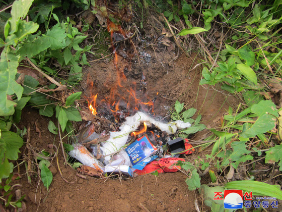 Materials believed to be anti-Pyongyang leaflets from South Korea burn after being discovered in North Korea, in this photo released by the North's Korean Central News Agency on Sunday. [YONHAP]