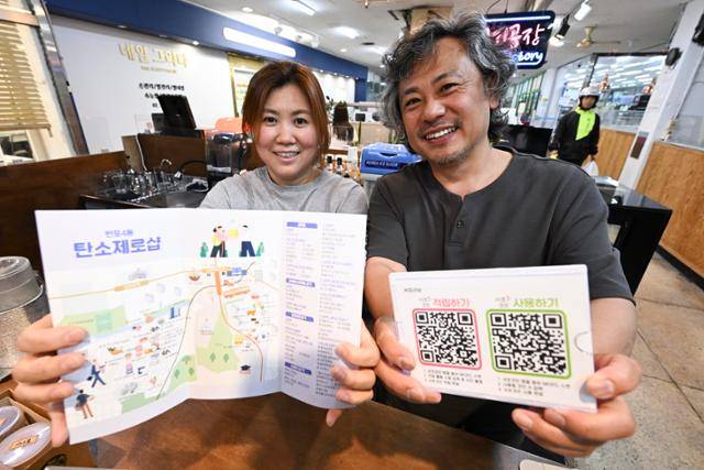 지난해부터 '탄소제로샵'에 참여 중인 정육점 '고기공장' 사장인 민홍기(오른쪽)씨와 카페 '커피라보' 사장인 민씨의 부인이 탄소제로샵 관련 팸플릿을 들어 보이고 있습니다. 주민들이 거주 지역 내 탄소제로샵 위치를 알 수 있게 행정복지센터 등에 이런 팸플릿을 비치해놓는다고 합니다. 정다빈 기자