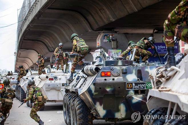 장갑차에서 내리는 방글라데시 군 (다카 AFP=연합뉴스) 20일(현지시간) 방글라데시 수도 다카에서 군인들이 순찰하기 위해 장갑차에서 내리고 있다. 2024.7.21. photo@yna.co.kr