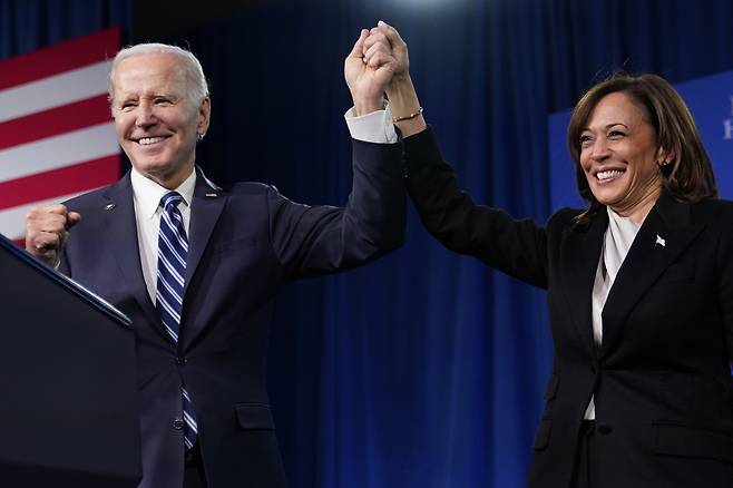 President Joe Biden (left) and Vice President Kamala Harris stand on stage at the Democratic National Committee winter meeting, on Feb. 3, 2023, in Philadelphia. (AP)