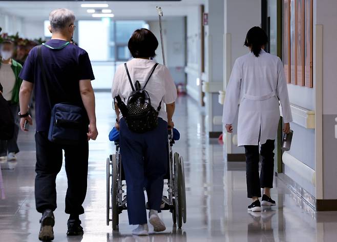 정부의 의대 정원 확대에 반발하며 의료계의 집단행동이 이어지고 있는 23일 오전 서울 시내 한 대학병원에서 의사와 환자가 이동하고 있다. 뉴스1