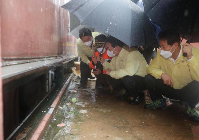 2022년 8월 윤석열(오른쪽 두 번째) 대통령이 침수 피해로 숨진 일가족이 살았던 서울 관악구 신림동 반지하 집을 방문해 소방관계자로부터 설명을 듣고 있다. 연합뉴스