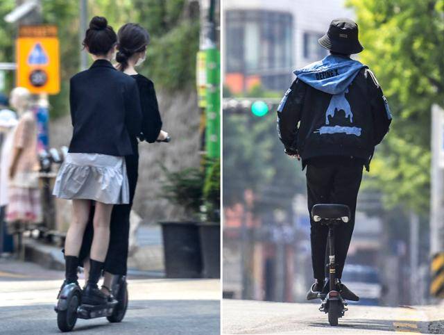 전동 킥보드 등 개인형 이동장치의 운전자 안전을 강화한 도로교통법 개정안이 시행된 2021년 5월 13일 오후 서울 마포구에서 두 사람이 하나의 전동킥보드를 타고 차량 진입금지 도로에 들어가고 있다(왼쪽). 같은 장소에서 한 킥보드 운전자가 안전모를 착용하지 않고 운행하고 있다. 이한호 기자