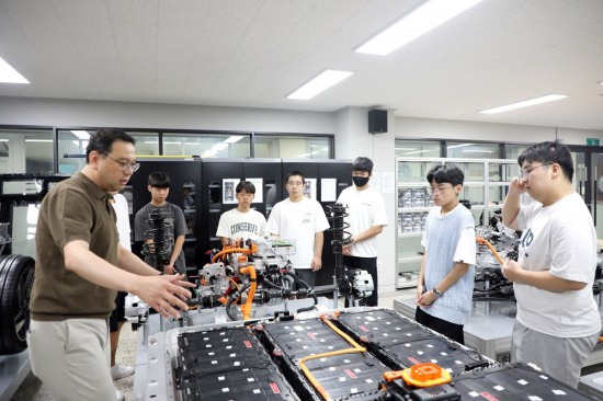 스마트e-자동차과 류경진 교수가 학생들에게 전기자동차와 베터리에 대해 설명하고 있다.[영남이공대 제공]