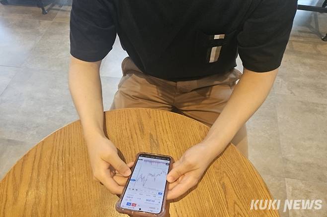 카페에서 한 남성이 스마트폰으로 주가를 확인하고 있다. 사진=김태훈 쿠키청년기자