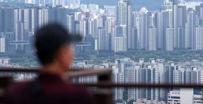 15일 오후 서울 용산구 남산에서 서울 도심 아파트를 시민이 보고 있다./사진=뉴시스