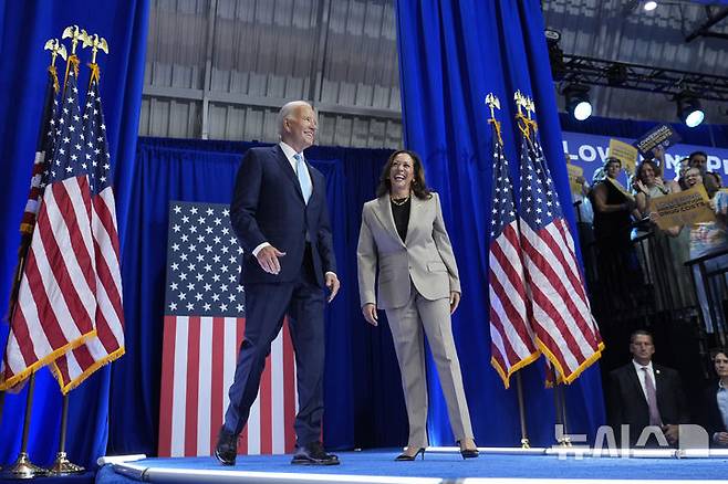 President Joe Biden, left, and Democratic presidential nominee Vice President Kamala Harris arrive to speak about the administration's efforts to lower costs during an event at Prince George's Community College in Largo, Md., Thursday, Aug. 15, 2024. (AP Photo/Susan Walsh)