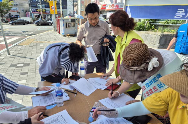 동일조선이전추진위원회가 부산 사하구 동일조선 앞 인도에서 서명 운동을 하는 모습.  추진위 제공