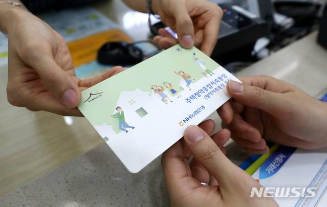 [서울=뉴시스]이영환 기자 = '청년우대형 주택청약종합저축통장'이 출시된 31일 서울 중구 NH농협은행 본점영업부에서 한 청년이 주택청약종합저축 통장을 받고 있다.청년우대형 주택청약종합저축은 청년층을 대상으로 10년간 연 최대 3.3%의 금리와 이자소득 비과세 혜택을 제공하는 상품이며, 주택청약 조건 및 소득공제혜택은 기존 주택청약종합저축과 동일하다. 2018.07.31.  20hwan@newsis.com