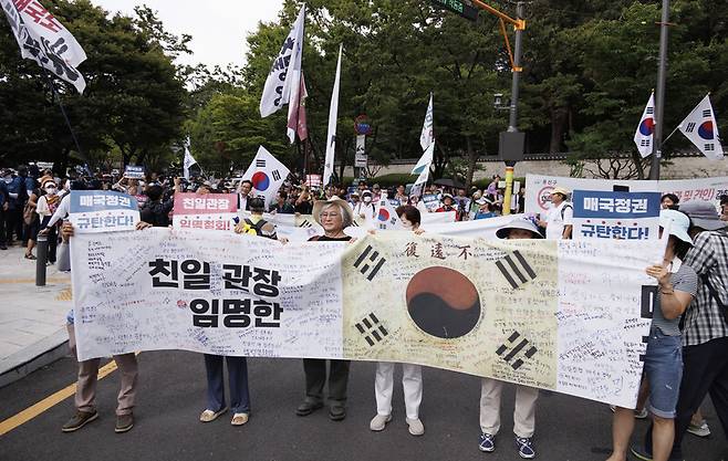 제79주년 광복절인 15일 항일독립선열 선양단체 연합(항단연)이 서울 용산구 효창공원 내 삼의사 묘역에서 개최한 광복절 기념식을 마친 참석자들이 독립기념관장 임명 철회 등을 요구하며 행진을 하고 있다. 연합뉴스