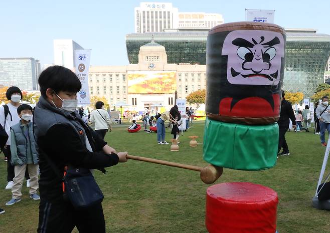 2022년 10월 22일 서울 중구 서울광장에서 열린 서울세계도시문화축제에서 시민들이 일본의 다루마오토시 놀이를 체험하고 있다. /뉴스1