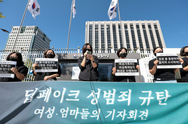 30일 정부서울청사 앞에서 열린 '딥페이크 성범죄 규탄 여성·엄마들의 기자회견'에서 참가자들이 손팻말을 들고 성명을 발표하고 있다. 연합뉴스