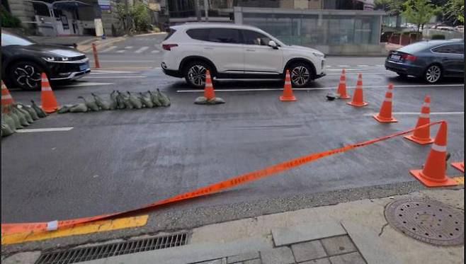 A road in front of Eonju Station in Gangnam-gu, Seoul, is partially blocked after land sinking occurred on August 31. Yonhap News