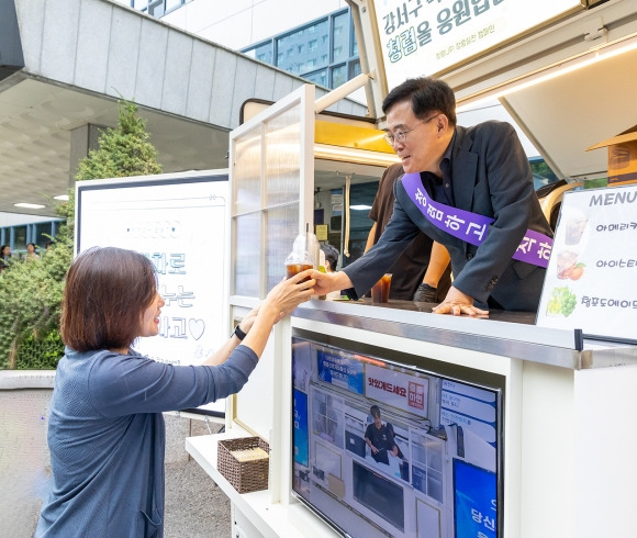 진교훈(오른쪽) 서울 강서구청장이 지난달 27일 강서구청 앞에 설치된 커피차에서 직원들에게 음료를 나눠 주며 청렴 캠페인을 벌이고 있다.  강서구 제공