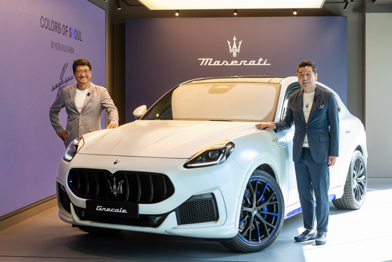 Designer Ken Okuyama and Maserati Korea Managing Director Takayuki Kimura pose with the Colors of Seoul edition of the Grecale SUV. [MASERATI KOREA]