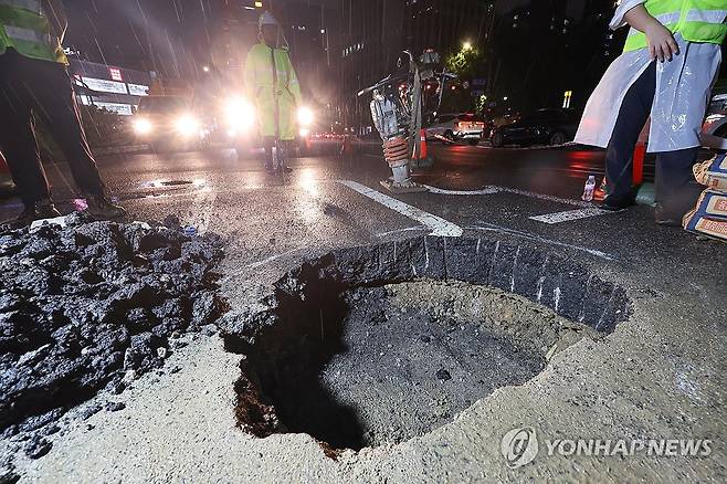 경복궁역 인근 포트홀 복구 작업 (서울=연합뉴스) 신현우 기자 = 20일 오후 서울 지하철 3호선 경복궁역에서 사직터널 방향으로 가는 사직로에 도로파임(포트홀)이 발생해 복구 작업이 이뤄지고 있다.
    포트홀은 가로 40㎝·세로 20㎝, 깊이 70㎝ 크기로 발생했다. 접수된 피해는 없었다. 2024.7.20 nowwego@yna.co.kr