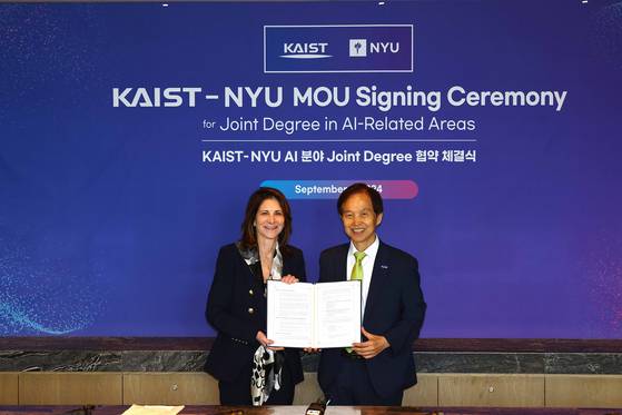 New York University President Linda G. Mills, left, and KAIST President Lee Kwang-hyung pose for a photo after signing a memorandum of understanding to create a joint degree program for graduate students in AI on Monday. [KAIST]