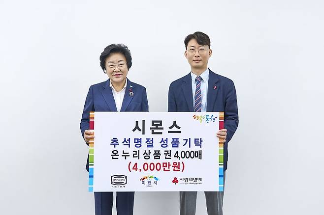 이종성 시몬스 부사장(오른쪽)이 지난 5일 이천시청에서 온누리상품권 기부식을 진행한 뒤 김경희 이천시장과 기념 촬영을 하고 있다. 시몬스 제공