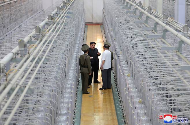 In this undated photo, North Korean leader Kim Jong-un (center, rear) is seen inspecting an uranium enrichment facility. (KCNA-Yonhap)