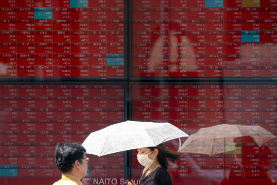 9월 12일 행인들이 일본 도쿄증권거래소 앞 전광판을 지나가고 있다. (사진=AFP)