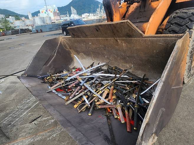 This photo provided by Busan Metropolitan Police Agency shows swords collected after their permits were revoked.