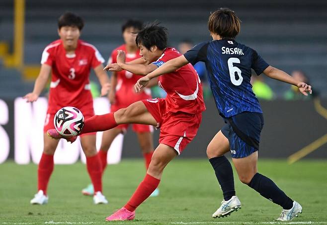 23일(한국시각) 콜롬비아 보고타 네메시오 카마초 엘 캄핀 경기장에서 열린 2024년 국제축구연맹(FIFA) U-20 여자 월드컵 결승전 북한과 일본의 경기에서 북한의 박미령(가운데)이 일본의 수비수 리오 사사키(6번) 옆에서 공을 차고 있다. 보고타/AFP 연합뉴스