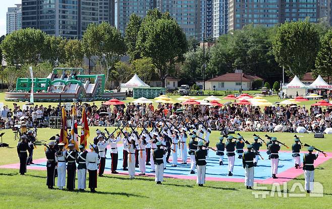 [서울=뉴시스] 김금보 기자 = 건군 76주년 국군의 날을 이틀 앞둔 29일 서울 용산구 용산어린이정원에서 열린 '군 문화 페스타'를 찾은 시민들이 의장대 시범을 관람하고 있다. 2024.09.29. kgb@newsis.com