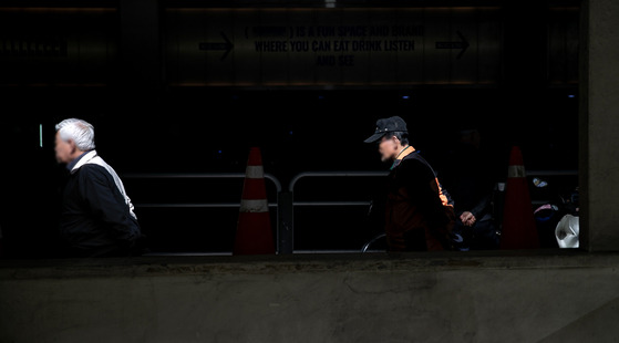 Pedestrians stroll near Tapgol Park in central Seoul on Friday. [NEWS1]