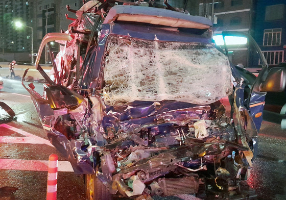 The destroyed cargo truck being towed at the site of the car crash that happened on the Gyeongin Expressway on Monday. [INCHEON FIRE HEADQUARTERS]