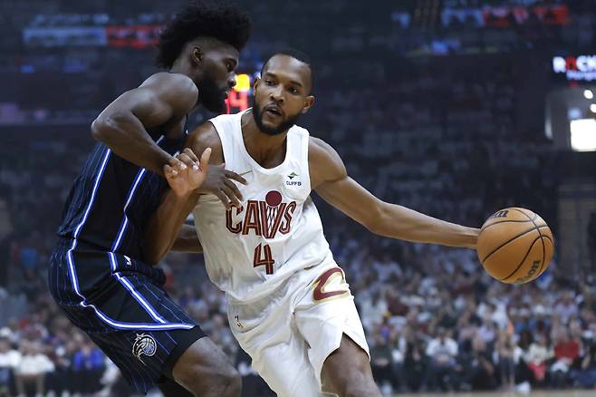 FILE - Cleveland Cavaliers forward Evan Mobley (4) drives against Orlando Magic forward Jonathan Isaac during the first half of Game 2 of an NBA basketball first-round playoff series, April 22, 2024, in Cleveland. Mobley has agreed to a five-year, $224 million contract extension with Cleveland, a person familiar with the negotiations told The Associated Press on Saturday, July 20. (AP Photo/Ron Schwane, File)