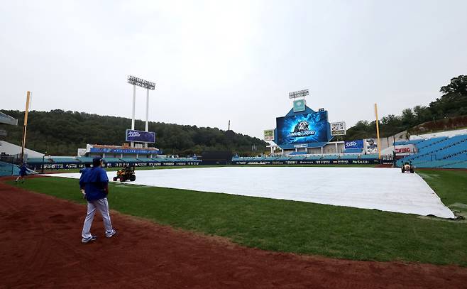 14일 2024 프로야구 KBO 포스트시즌 삼성라이온즈와 LG트윈스의 플레이오프(PO) 2차전 경기가 열릴 예정인 대구삼성라이온즈파크에 약하게 비가 내리는 가운데 그라운드에 대형 방수포가 덮여있다. 대구=김민규 기자 mgkim1@edaily.co.kr /2024.10.14/