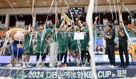 Wonju DB Promy celebrate winning the 2024 KBL Cup at Jecheon Stadium in Jecheon, North Chungcheong on Sunday. [YONHAP]