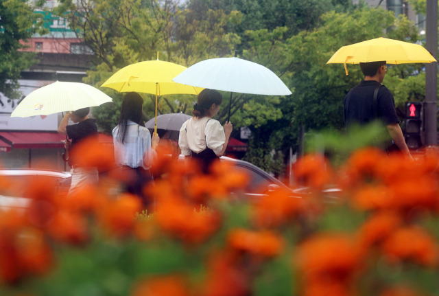 ▲ 시민들이 내리는 비에 우산을 쓰고 이동하고 있다. ⓒ연합뉴스