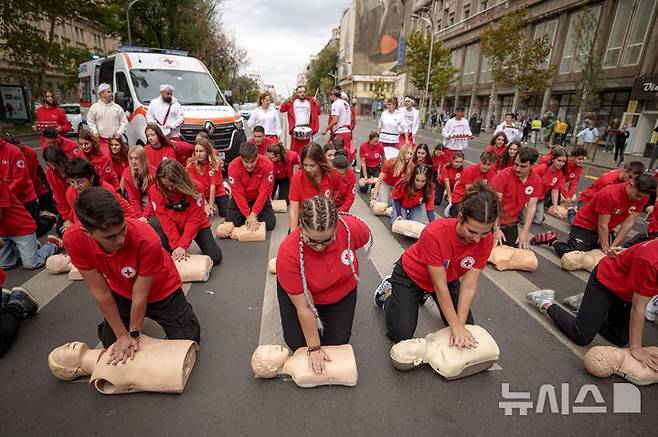 [부쿠레슈티=AP/뉴시스] 16일(현지시각) 루마니아 부쿠레슈티에서 세계 심폐소생의 날을 기념하는 플래시몹이 열려 루마니아 적십자 대원들이 마네킹을 이용해 심폐소생술(CPR)을 하고 있다.  10월 16일은 '세계 심폐소생의 날'로 응급상황을 대비해 많은 사람이 CPR을 배울 수 있게 교육해야 한다는 취지로 제정됐다. 미국심장협회는 그룹 '비지스'의 히트곡 '스테잉 얼라이브'를 CPR 시행 시 리듬 맞추기 좋은 노래로 선정한 바 있다. 2024.10.17.