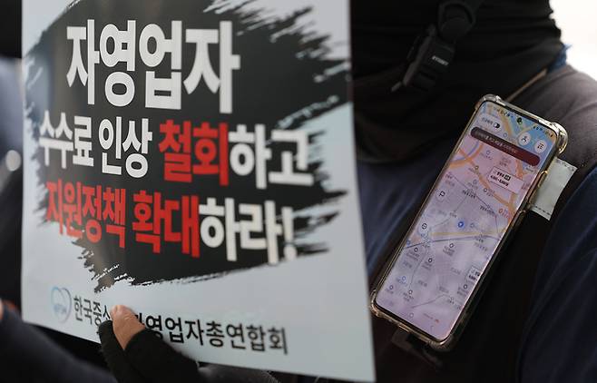 배달플랫폼노동조합이 지난 8월27일 오전 서울 영등포구 배달의 민족 B마트 앞에서 연 ‘B마트 멈춤의 날 선포 기자회견’에서 참가자들이 배달 관련 앱을 켜둔 채로 손팻말을 들고 있다. 연합뉴스