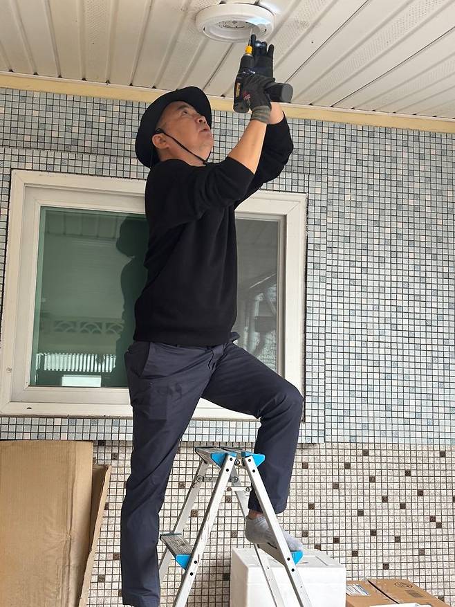 [밀양=뉴시스] 안지율 기자 = 정홍재 루나 대표가 삼문동 6·25 참전유공자 가정을 방문해 노후 전등을 LED 등으로 교체하는 봉사활동을 펼쳤다. (사진=밀양시의회 제공) 2024.10.23. photo@newsis.com  *재판매 및 DB 금지