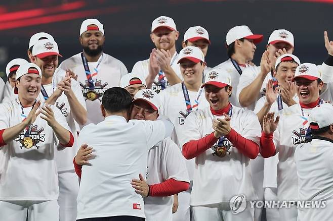 28일 광주 기아챔피언스필드에서 2024 신한 SOL뱅크 KBO 포스트시즌 한국시리즈 우승팀 KIA 타이거즈 선수단이 시상식에 참여한 가운데 심재학 단장과 이범호 감독이 포옹하고 있다. 연합뉴스