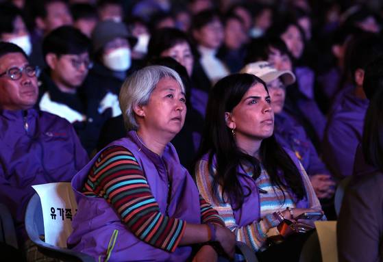 Bereaved families of the Itaewon tragedy watch a performance held as part of a memorial event near City Hall in central Seoul on Saturday. [JOINT PRESS CORPS]