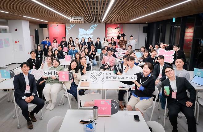 SM Entertainment's staff poses for a group photo at the agency's internal discussion session ″SMile Impact″ on Wednesday. [SM ENTERTAINMENT]