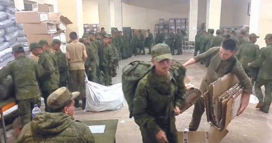 A screengrab shows soldiers, believed to be North Koreans, receiving basic supplies at a Russian training base in a video provided by the Ukrainian Center for Strategic Communication and Information Security, also known as Spravdi. [SCREEN CAPTURE]