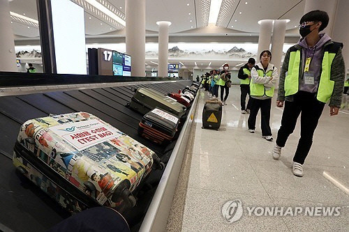 인천공항 제2여객터미널 4단계 확장 현장에서 열린 종합시험운영에서 가상승객들이 수하물을 찾고 있다. 인천공항 4단계 확장 사업은 대부분 공사가 마무리돼 연내 운영을 시작할 계획이다. [영종도=연합뉴스]