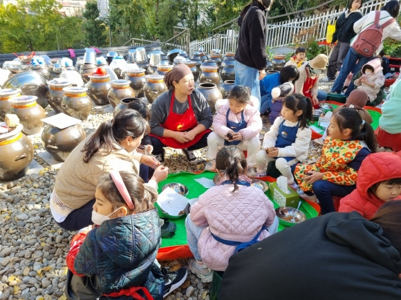 지난 6일 서울 중구 동화동 주민센터 동화장독대 마당에서 열린 ‘장 나누기’ 행사에서 전문 강사가 지역 어린이들에게 간장과 된장 등에 대해 설명하고 있다. 중구 제공