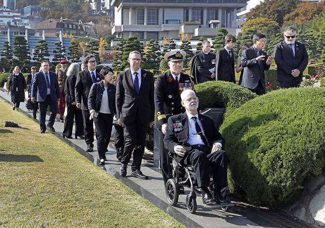 Sgt. Donald Northey's son Michael Northey, first from right, is accompanied out from Tuesday's rededication ceremony at the United Nations Memorial Cemetery in Busan by Brig. Gen. Andy Lamb, the British defense attache in Korea, and British Ambassador to Korea Colin Crooks, second and third from right. [PARK SANG-MOON]