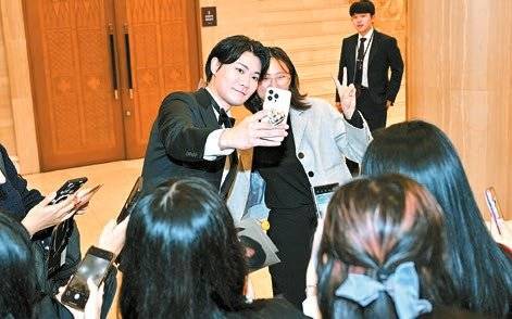 현장을 찾은 팬과 인증샷을 찍고 있는 크리에이터 닛몰캐쉬(왼쪽).