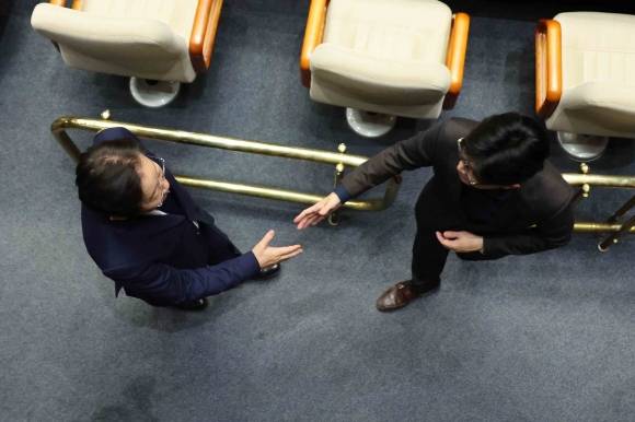 윤석열 대통령이 긴급 대국민 담화를 통해 비상계엄령을 발표한 가운데 4일 새벽 서울 여의도 국회 본회의장에서 한동훈 국민의힘 대표와 이재명 더불어민주당 대표가 악수하고 있다. 2024.12.4 뉴시스